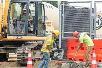 Construction workers continue work on a new parking garage in Dover, Del., on July 21, 2026.