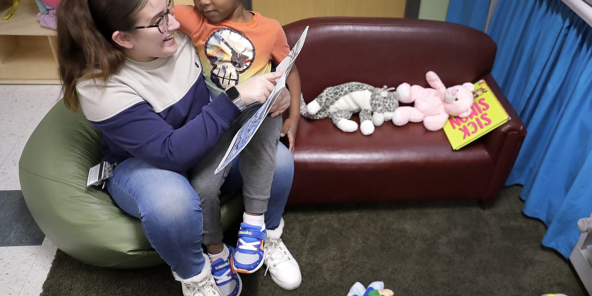 Teaching assistant Anna Muniz reads a book together during a Head Start preschool class in Wisconsin on Thursday, April 4, 2024.