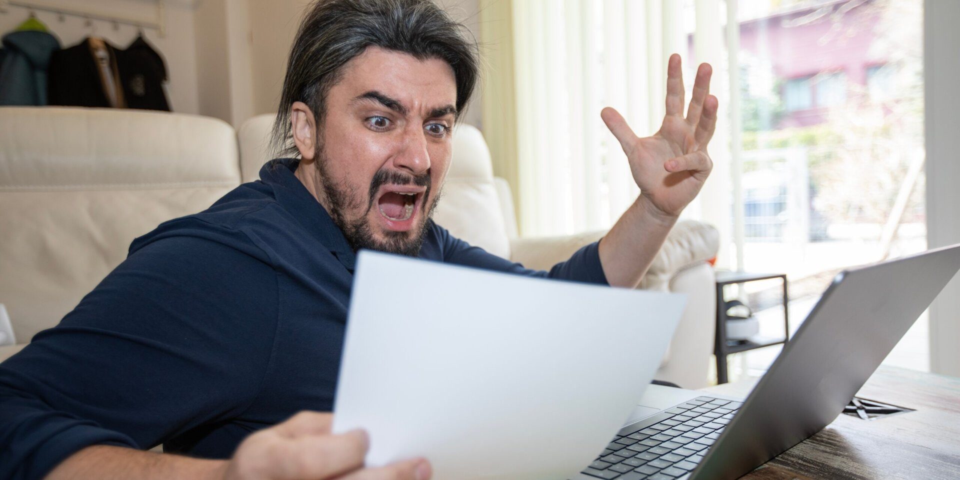 Handsome,Young,Man,Shocked,Over,High,Bill,In,Office